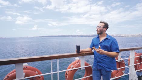 Young-man-eating-bagel-on-the-ferry,-slow-motion.